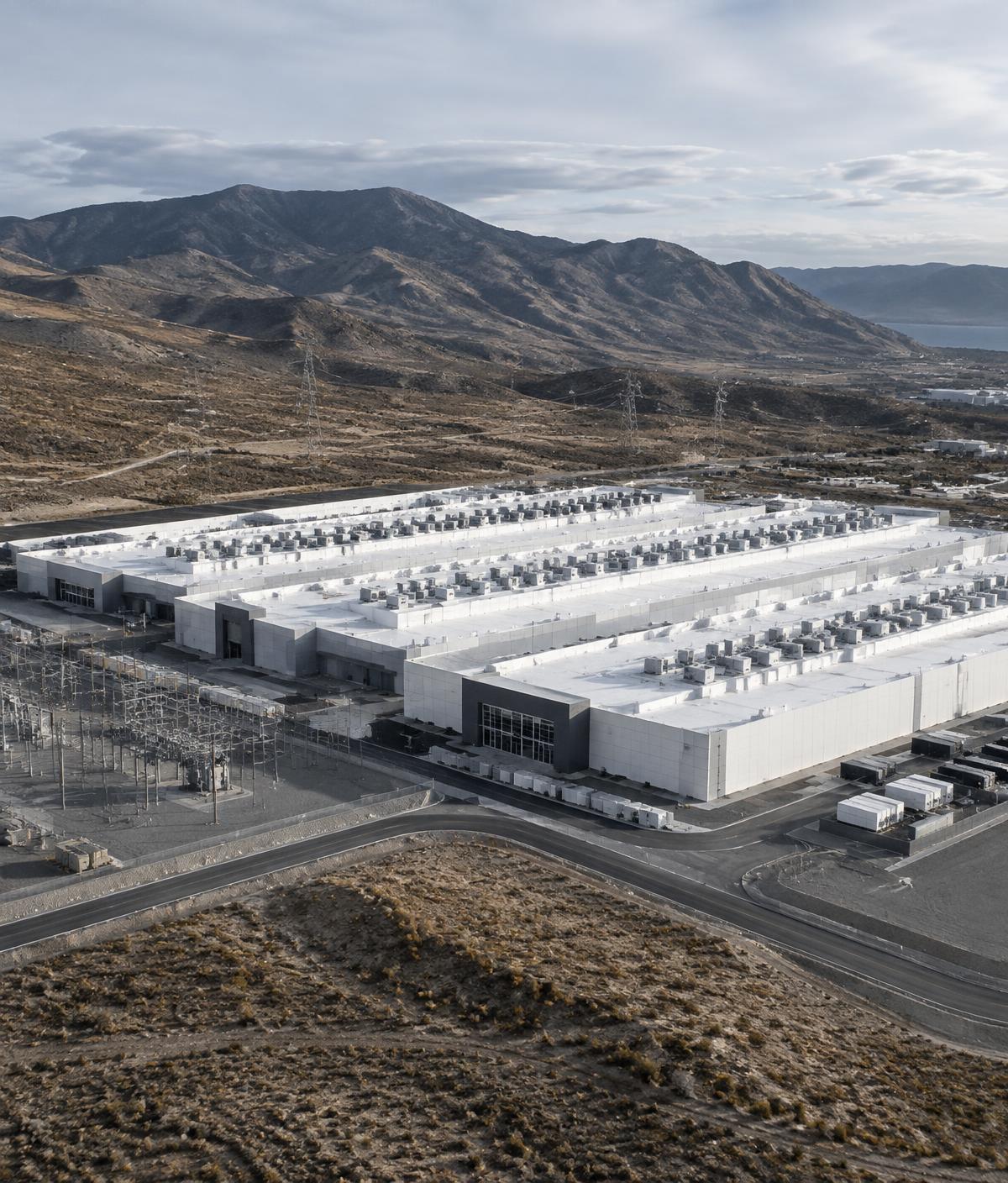 Aerial view of a data center campus beside a substation